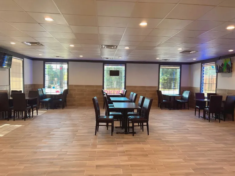 Spacious and bright dining area with tables and chairs at JD WINGS, an Fast food Restaurant in Columbus